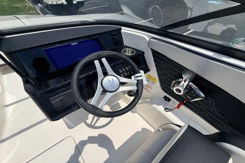 Slide: The Image of Interior of 2026 Sea Ray SPX 210 Outboard with steering and controls. - 7