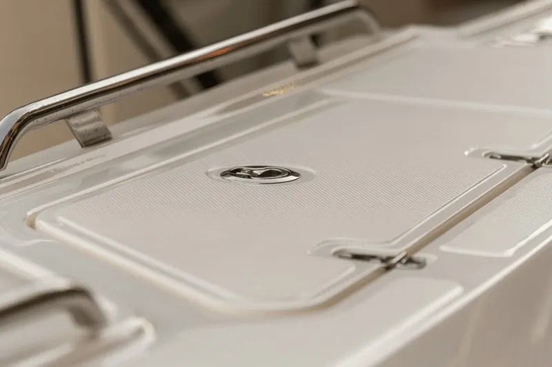 Slide: The Image of Close-up of a white deck with metal handle on a Boston Whaler 380 Realm boat. - 44