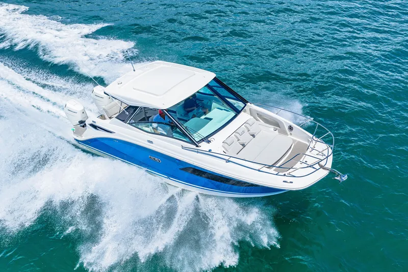Slide: The Image of A 2027 Sea Ray Sundancer 320 Outboard speeding across the blue water. - 21
