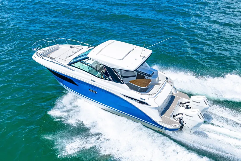 Slide: The Image of A 2027 Sea Ray Sundancer 320 Outboard speeds across the blue water. - 10