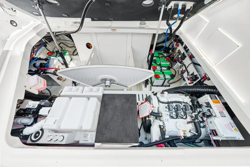 Slide: The Image of The engine compartment of a 2027 Sea Ray Sundancer 320 Outboard shows batteries and technical components. - 49