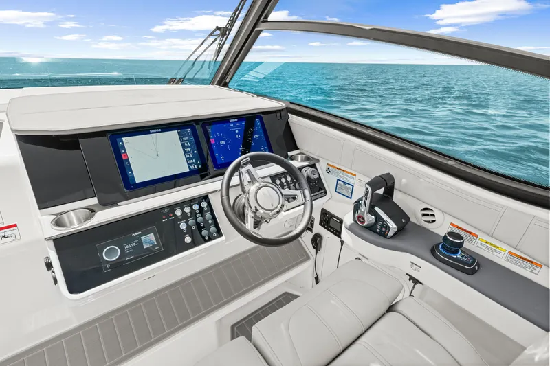 Slide: The Image of The cockpit of the 2027 Sea Ray Sundancer 320 Outboard features modern navigation systems and controls. - 34