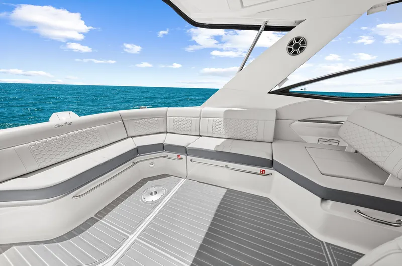 Slide: The Image of The image shows the luxurious cockpit of a Sea Ray Sundancer 320 Outboard with sleek gray upholstery. - 29