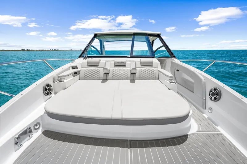 Slide: The Image of The image shows the spacious foredeck of a 2027 Sea Ray Sundancer 320 Outboard on the sea. - 39