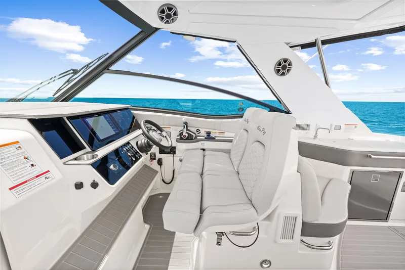Slide: The Image of The image shows the cockpit of a 2027 Sea Ray Sundancer 320 Outboard with a modern design. - 33