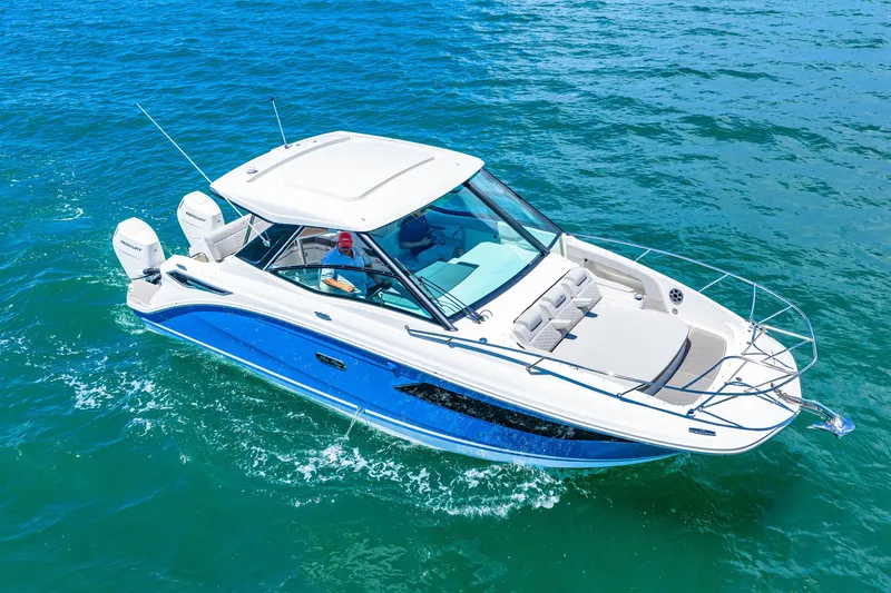 Slide: The Image of A modern 2027 Sea Ray Sundancer 320 Outboard cruising on blue water. It features sleek design, spacious deck, and twin outboard engines. - 3