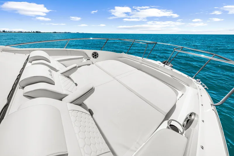 Slide: The Image of The image shows the deck of a 2027 Sea Ray Sundancer 320 Outboard with luxurious lounging areas. - 38