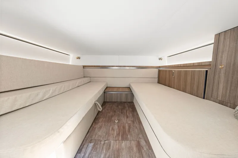 Slide: The Image of Interior of the 2027 Sea Ray Sundancer 320 Outboard with two beige benches and wooden flooring. - 48