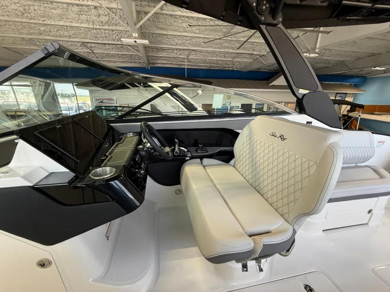Slide: The Image of The image shows the cockpit of a Sea Ray SLX 280 Outboard with beige seats and a modern helm. - 9