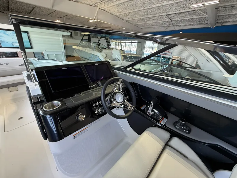 Slide: The Image of The image shows the cockpit of a 2027 Sea Ray SLX 280 Outboard with modern instruments. - 10