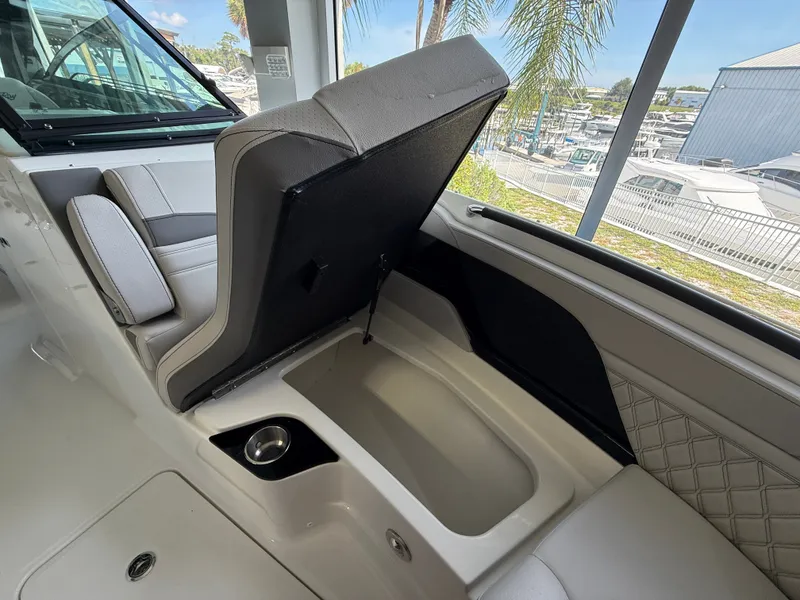 Slide: The Image of The image shows the interior of a Sea Ray SLX 280 Outboard with an open storage compartment under a seat. - 7