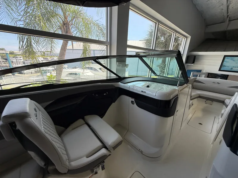 Slide: The Image of The image shows the cockpit of a Sea Ray SLX 280 Outboard with modern seating and large windows. - 12