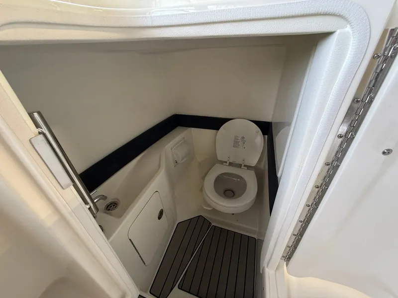 Slide: The Image of The Sea Ray SLX 280 Outboard 2027 cabin features a compact toilet with modern fixtures. - 15