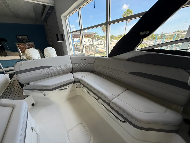 Slide: The Image of Interior view of a Sea Ray SLX 280 Outboard with sleek gray upholstery and large windows. - 18