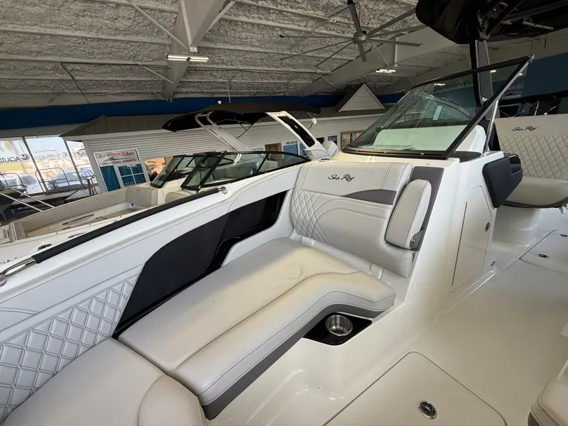 Slide: The Image of Interior view of a Sea Ray SLX 280 Outboard with sleek white upholstery and modern details. - 5