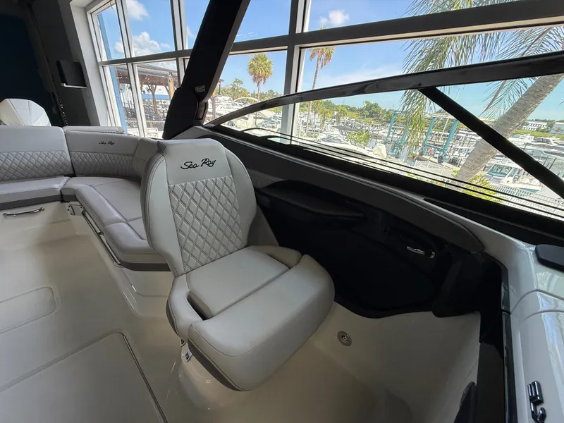 Slide: The Image of Interior view of a Sea Ray SLX 280 Outboard with sleek, upholstered seating and large windows. - 13