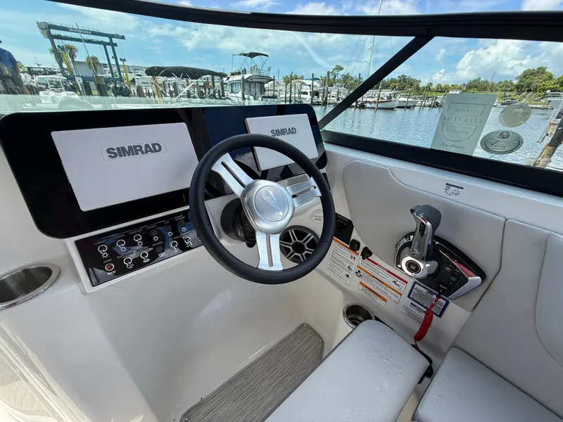 Slide: The Image of The image shows the helm of a Sea Ray SDX 270 Outboard with modern instruments and a comfortable seat. - 9