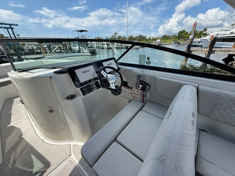 Slide: The Image of The image shows the cockpit of a Sea Ray SDX 270 Outboard with modern instruments and comfortable seating. - 8
