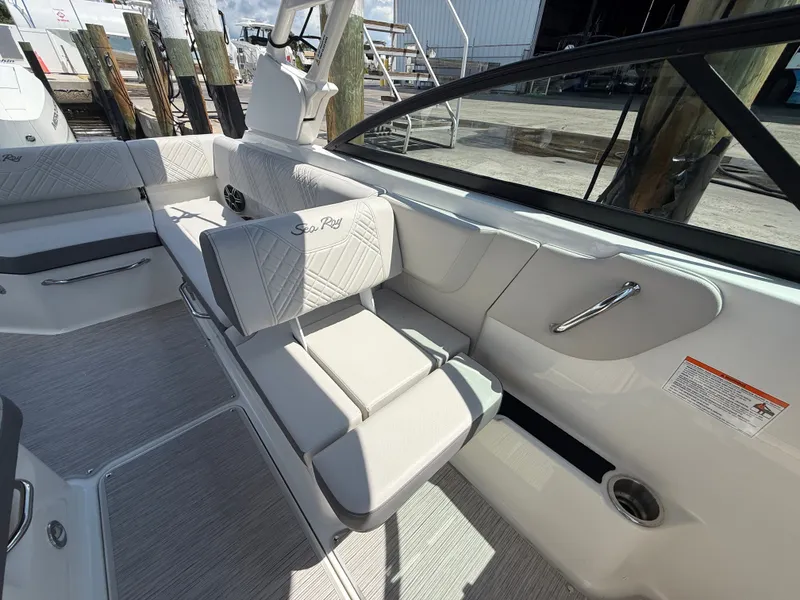 Slide: The Image of The image shows the interior of a Sea Ray SDX 270 Outboard boat with sleek white upholstery. - 12
