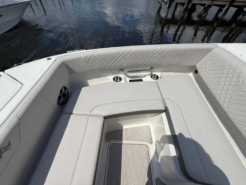 Slide: The Image of The image shows the sleek bow area of a Sea Ray SDX 270 Outboard with white upholstery and cup holders. - 4