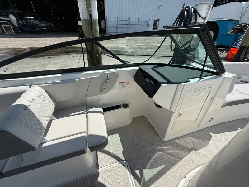 Slide: The Image of The image shows the cockpit of a 2027 Sea Ray SDX 270 Outboard with sleek seating and a modern helm. - 11