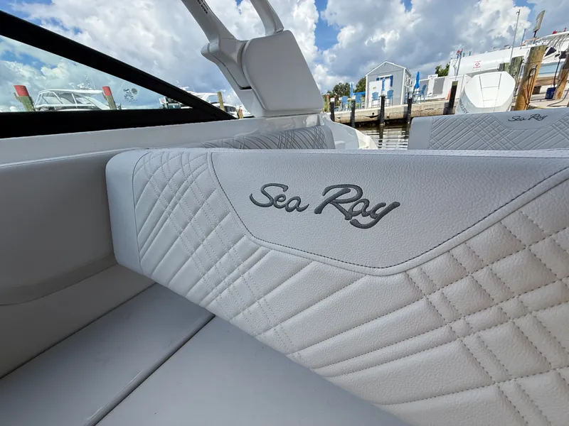 Slide: The Image of Close-up of a white Sea Ray SDX 270 Outboard seat with quilted pattern at a marina. - 10