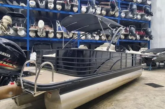 Slide: The Image of 2018 Bennington 23 GCWA pontoon boat in storage, featuring a Yamaha outboard motor. - 4