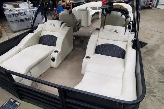 Slide: The Image of 2018 Bennington 23 GCWA pontoon boat with luxurious seating in a garage setting. - 5