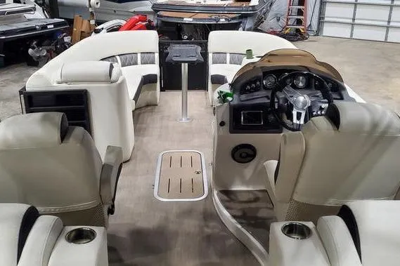 Slide: The Image of 2018 Bennington 23 GCWA pontoon boat interior with beige seating and steering console. - 6