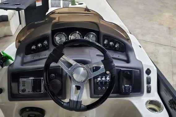 Slide: The Image of 2018 Bennington 23 GCWA boat dashboard with steering wheel and control gauges. - 7
