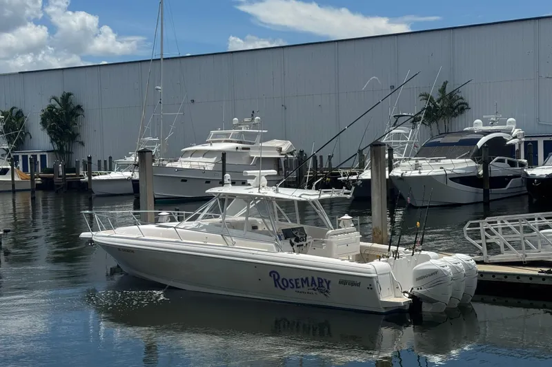 Slide: The Image of 2006 Intrepid 377 Walkaround boat docked at marina with other yachts. - 1