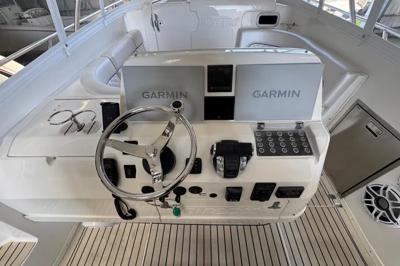 Slide: The Image of 2006 Intrepid 377 Walkaround helm with Garmin navigation, steering wheel, and control panel. - 10