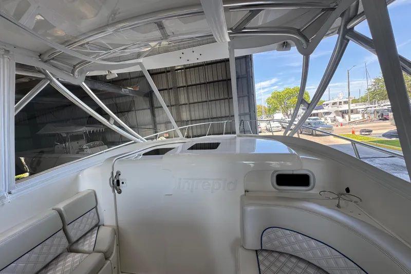 Slide: The Image of Interior view of a 2006 Intrepid 377 Walkaround boat with cushioned seating. - 12
