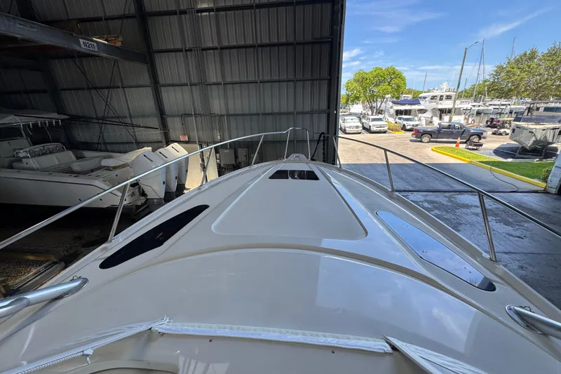 Slide: The Image of 2006 Intrepid 377 Walkaround boat in storage, view from bow, sunny day outside. - 13