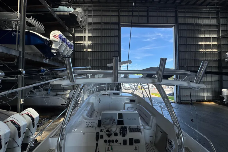 Slide: The Image of 2006 Intrepid 377 Walkaround boat in storage, featuring a sleek cockpit and advanced navigation equipment. - 14