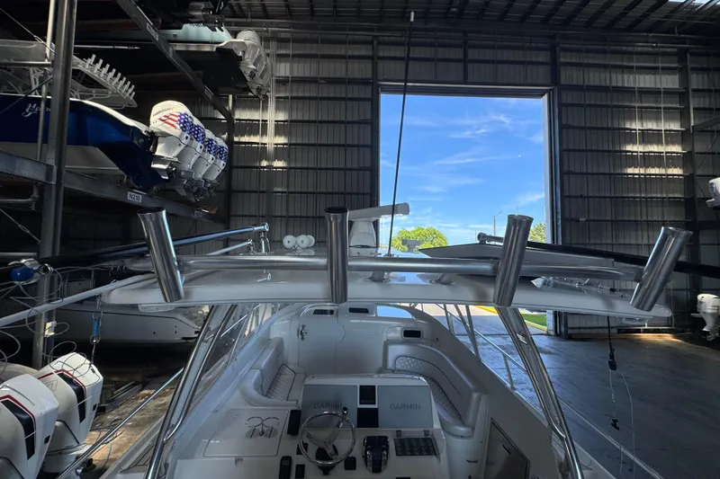 Slide: The Image of 2006 Intrepid 377 Walkaround boat in storage, featuring a sleek cockpit and advanced navigation equipment. - 16