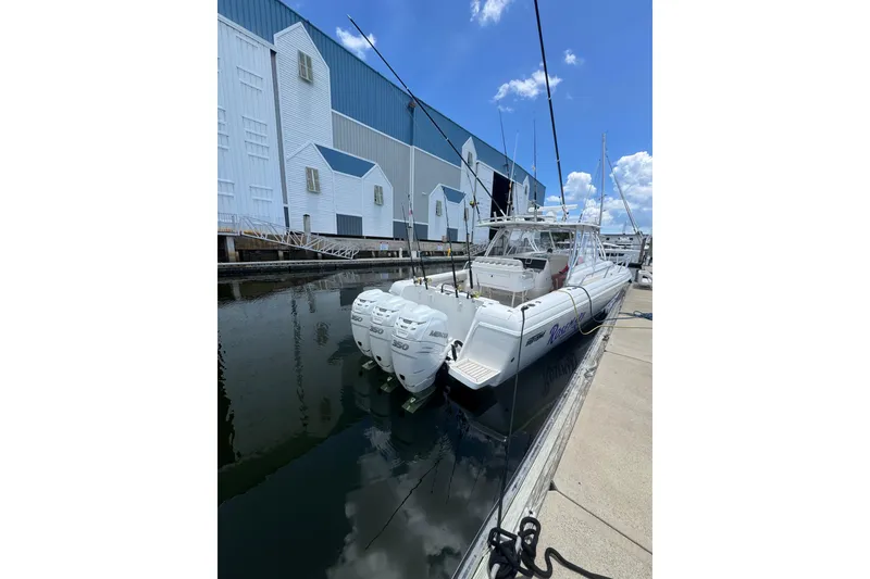 Slide: The Image of 2006 Intrepid 377 Walkaround boat docked with triple outboard engines. - 2