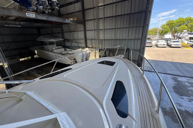 Slide: The Image of 2006 Intrepid 377 Walkaround boat in storage, showcasing sleek design and spacious deck. - 20