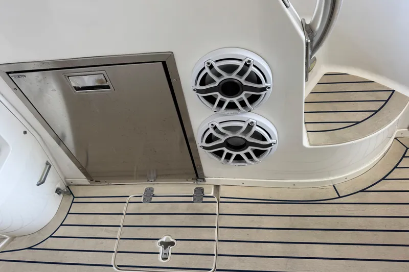 Slide: The Image of 2006 Intrepid 377 Walkaround boat deck with speakers and stainless steel hatch. - 21