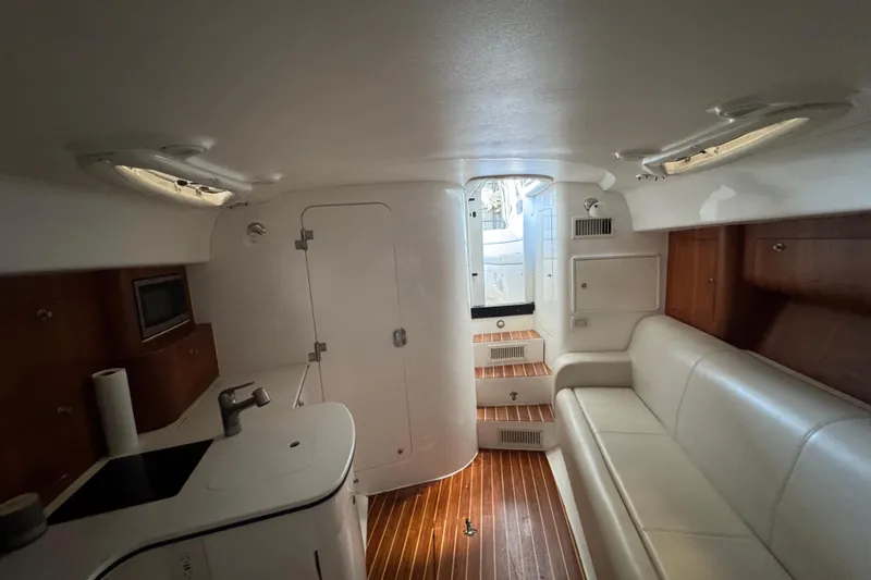 Slide: The Image of Interior of a 2006 Intrepid 377 Walkaround boat with seating and kitchenette. - 23
