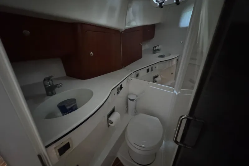 Slide: The Image of Bathroom interior of 2006 Intrepid 377 Walkaround boat with sink and toilet. - 24