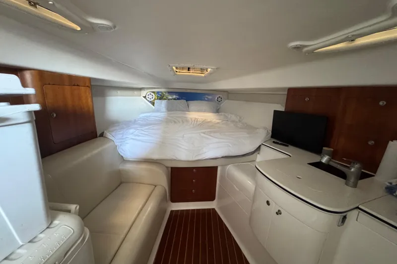 Slide: The Image of Interior of 2006 Intrepid 377 Walkaround boat with bed, seating, and kitchenette. - 28