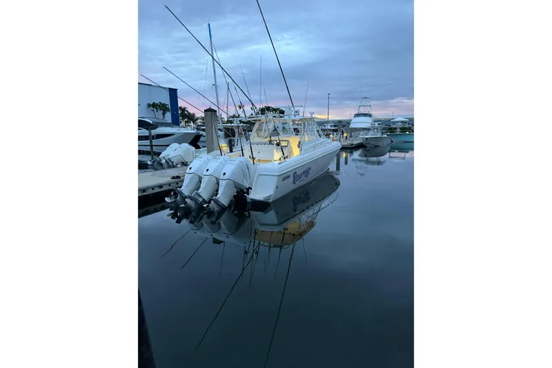 Slide: The Image of 2006 Intrepid 377 Walkaround boat docked at marina during twilight. - 3