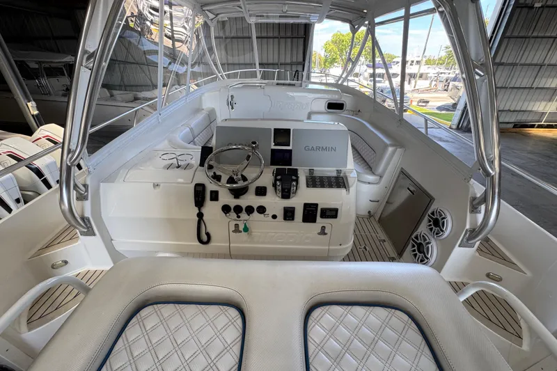 Slide: The Image of 2006 Intrepid 377 Walkaround boat cockpit with Garmin navigation system and luxurious seating. - 7