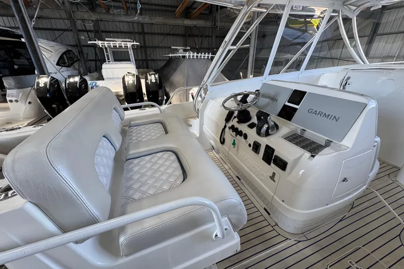 Slide: The Image of 2006 Intrepid 377 Walkaround boat interior with Garmin navigation system and dual seating. - 9