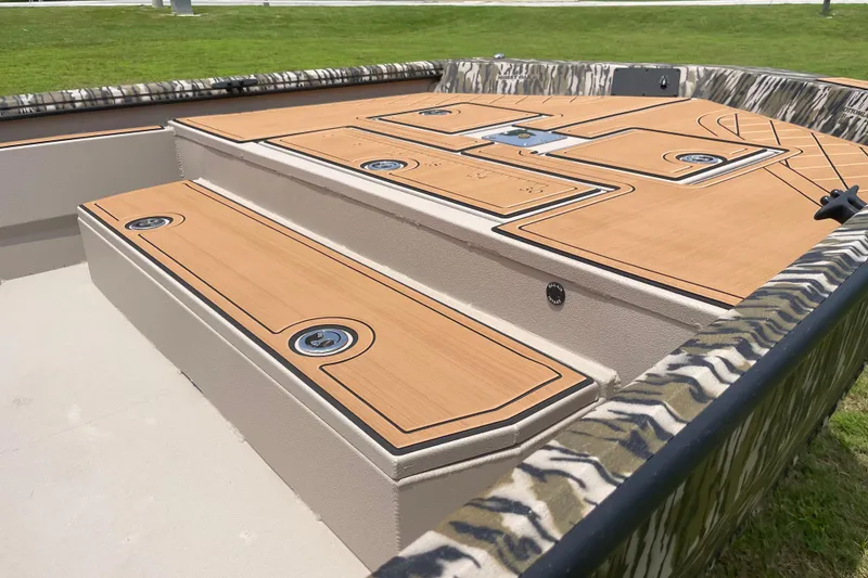 Slide: The Image of 2026 Avid 20 Rogue CC boat deck with camo trim and storage compartments. - 11