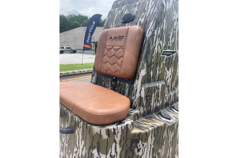 Slide: The Image of 2026 Avid 20 Rogue CC boat with camo design and brown leather seat. - 13