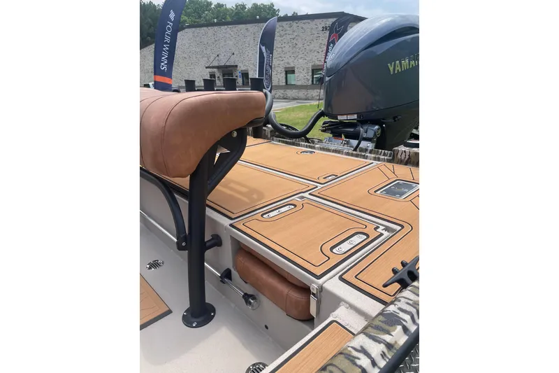 Slide: The Image of 2026 Avid 20 Rogue CC boat interior with Yamaha engine, featuring tan seating and deck. - 15