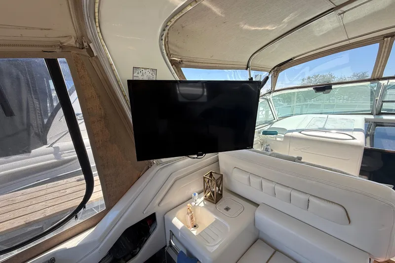 Slide: The Image of Interior of 1996 Sea Ray 400 Express Cruiser with TV and white seating. - 13