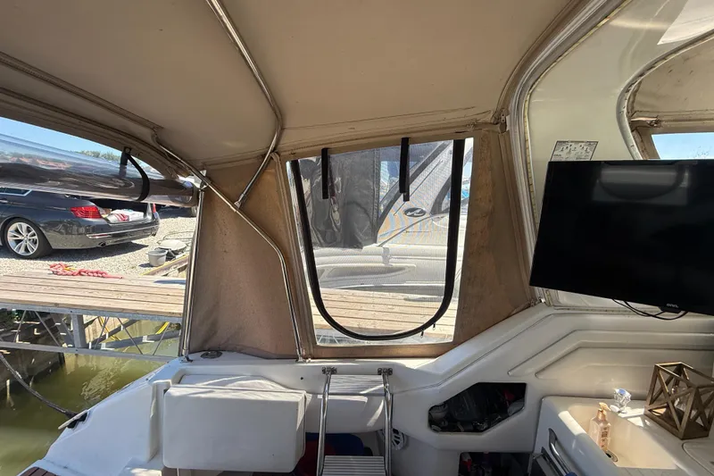 Slide: The Image of Interior view of a 1996 Sea Ray 400 Express Cruiser with dockside scenery. - 16